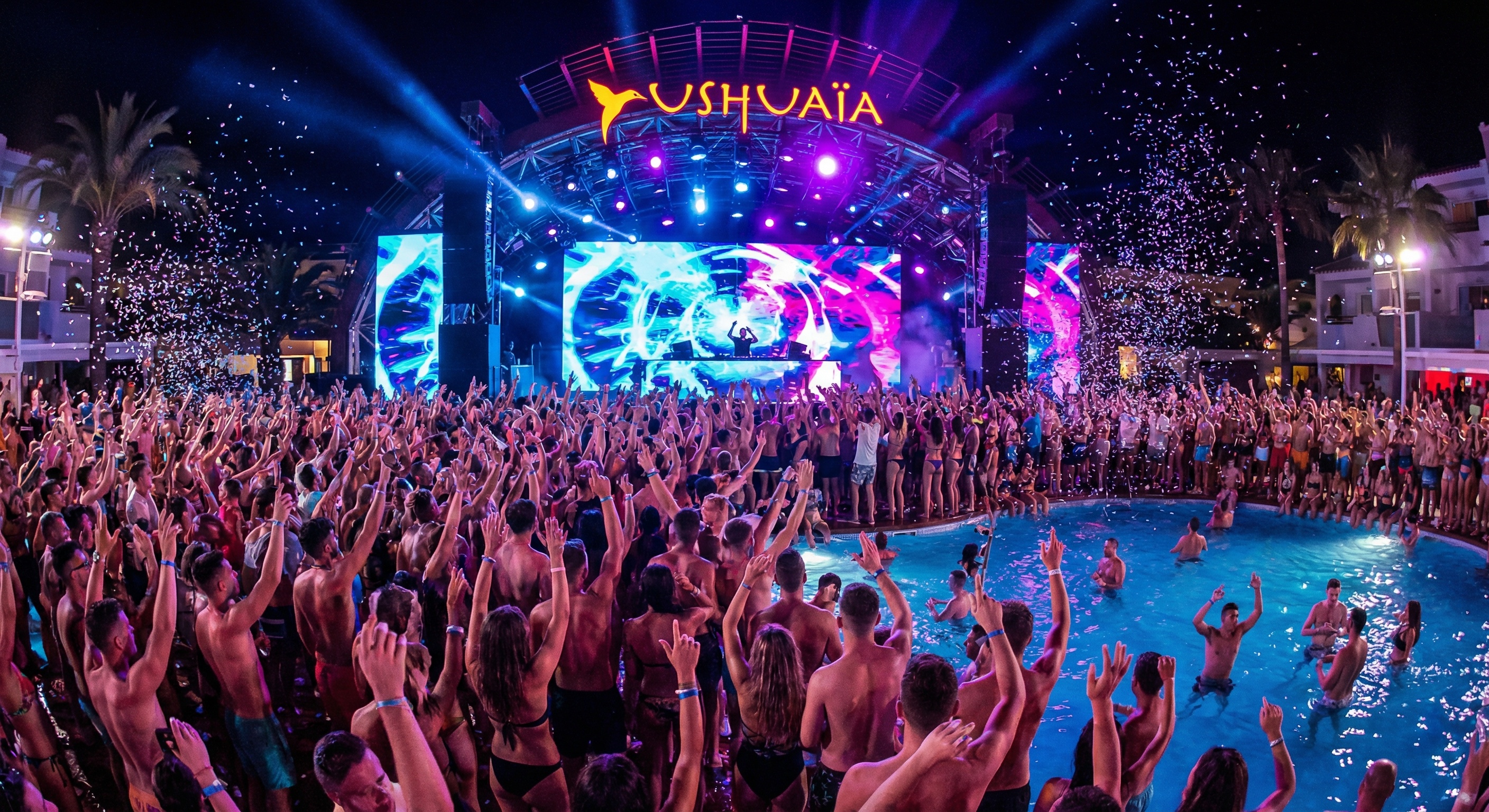 Ushuaïa Ibiza open-air club at sunset — crowd, LED stage, golden sky